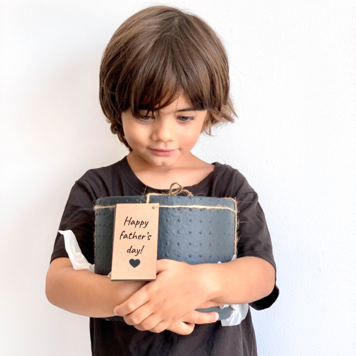 Midi Succulent mix in a charcoal handmade pot, midi jungle cacti mix held in young boys hands with personalised gift card. Biodegradable and recycled pot. Long-lasting and sustainable plant gift.